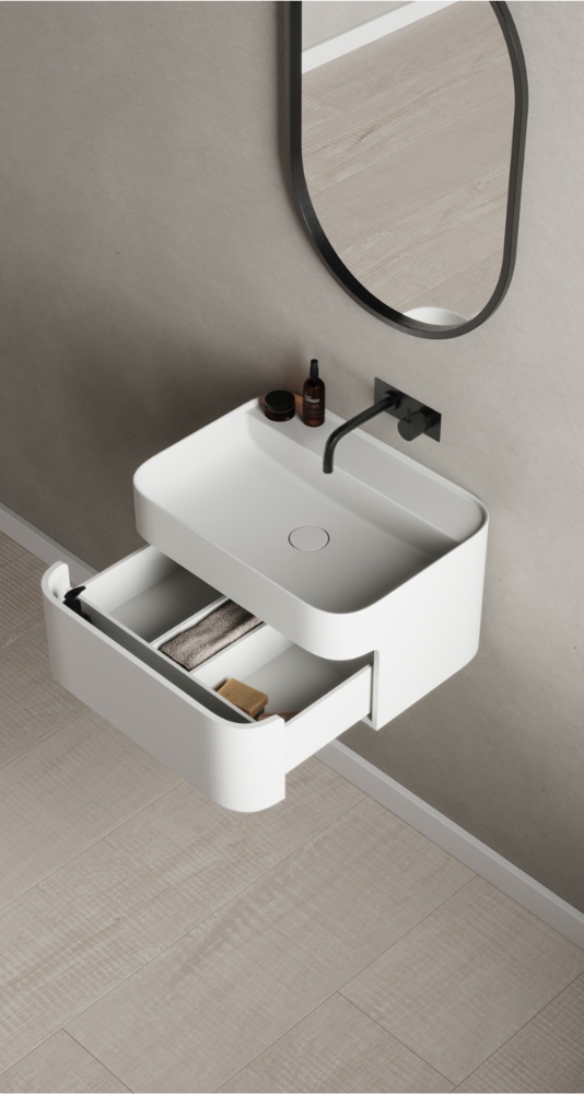 The elegant Yuno CA Wash Basin with drawer from Copenhagen Bath features Copenhagen minimalism, with soft, rounded corners contrasting sharp, clean edges for a sleek and exclusive design.