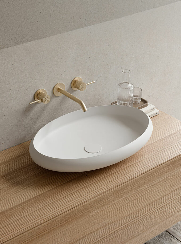 Rosenborg Oval basin made of matte white Acovi® Solid Surface mounted on top of a Bergen solid oak vanity unity